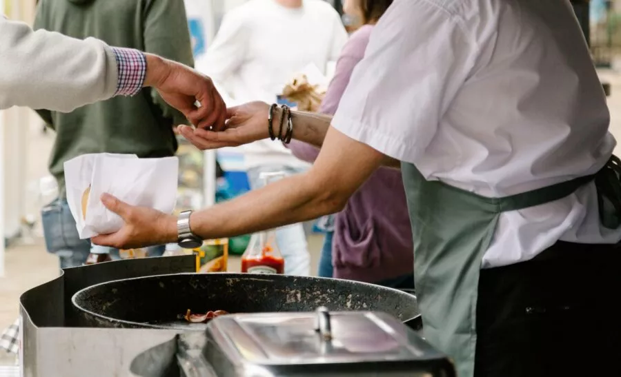 People buying food at a community market