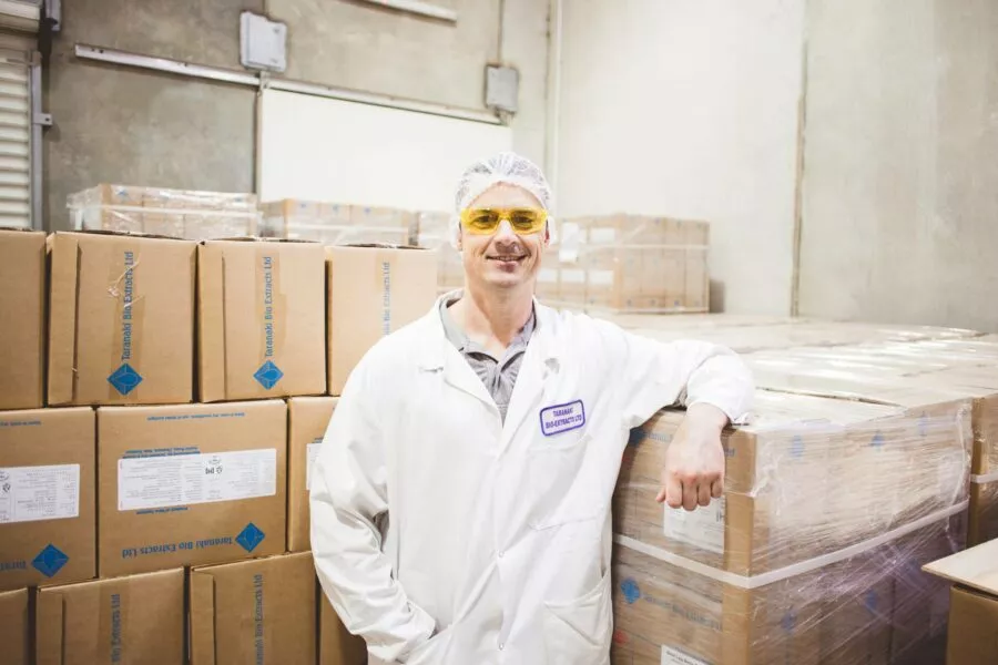 Employee in warehouse in front of recyclable packaging