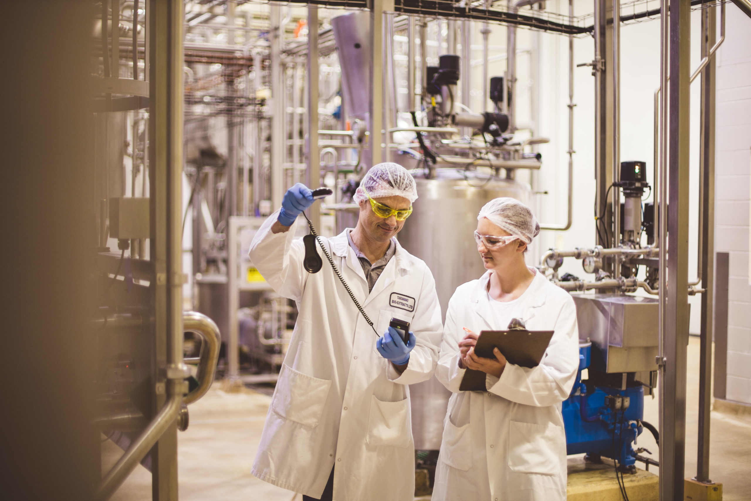 Two Taranaki Bio-Extracts' employees running a food safety test